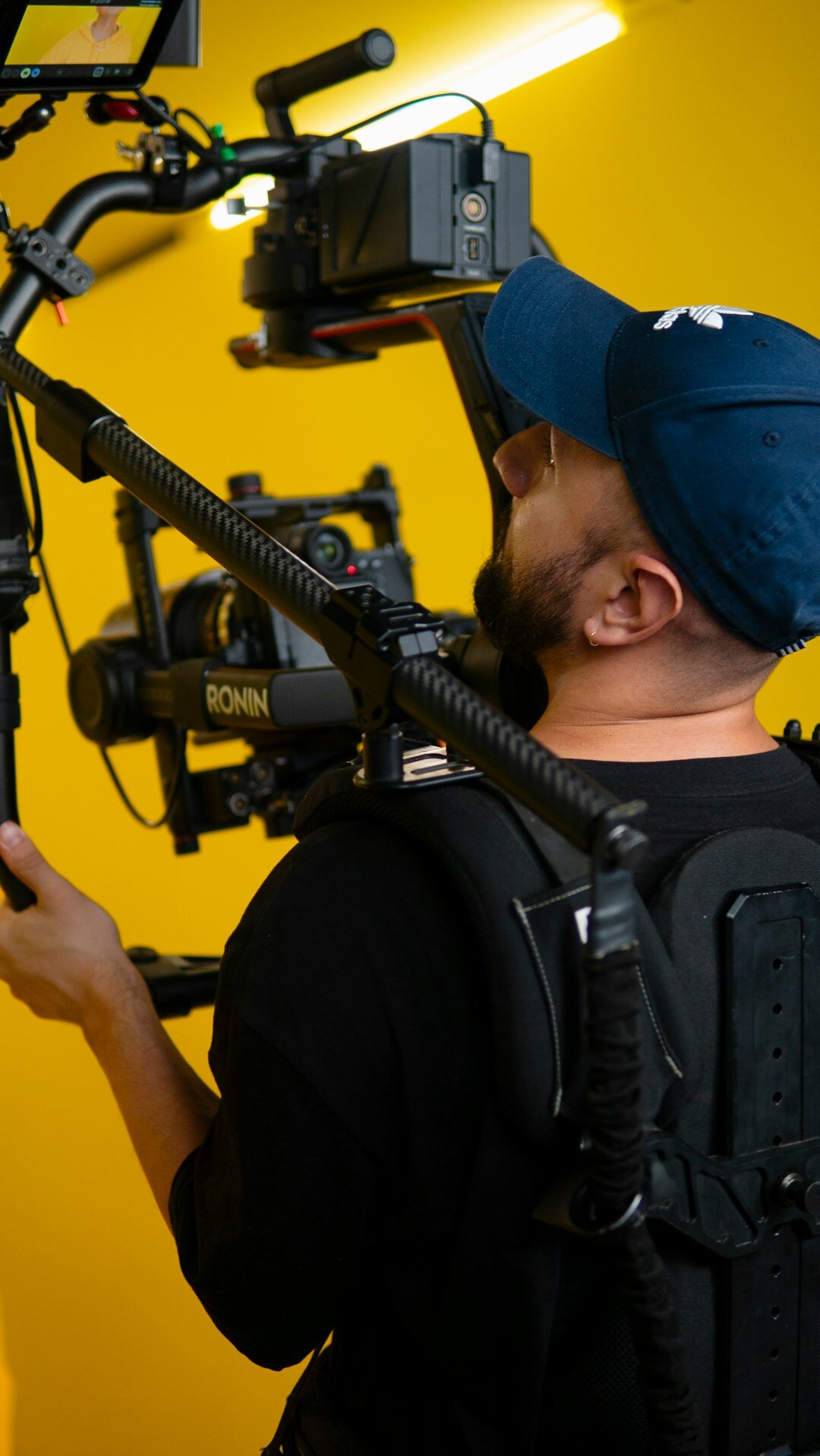 Camera operator with professional video camera on shoulder