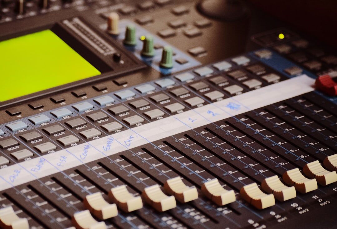 Close up of a video mixing console with sliders