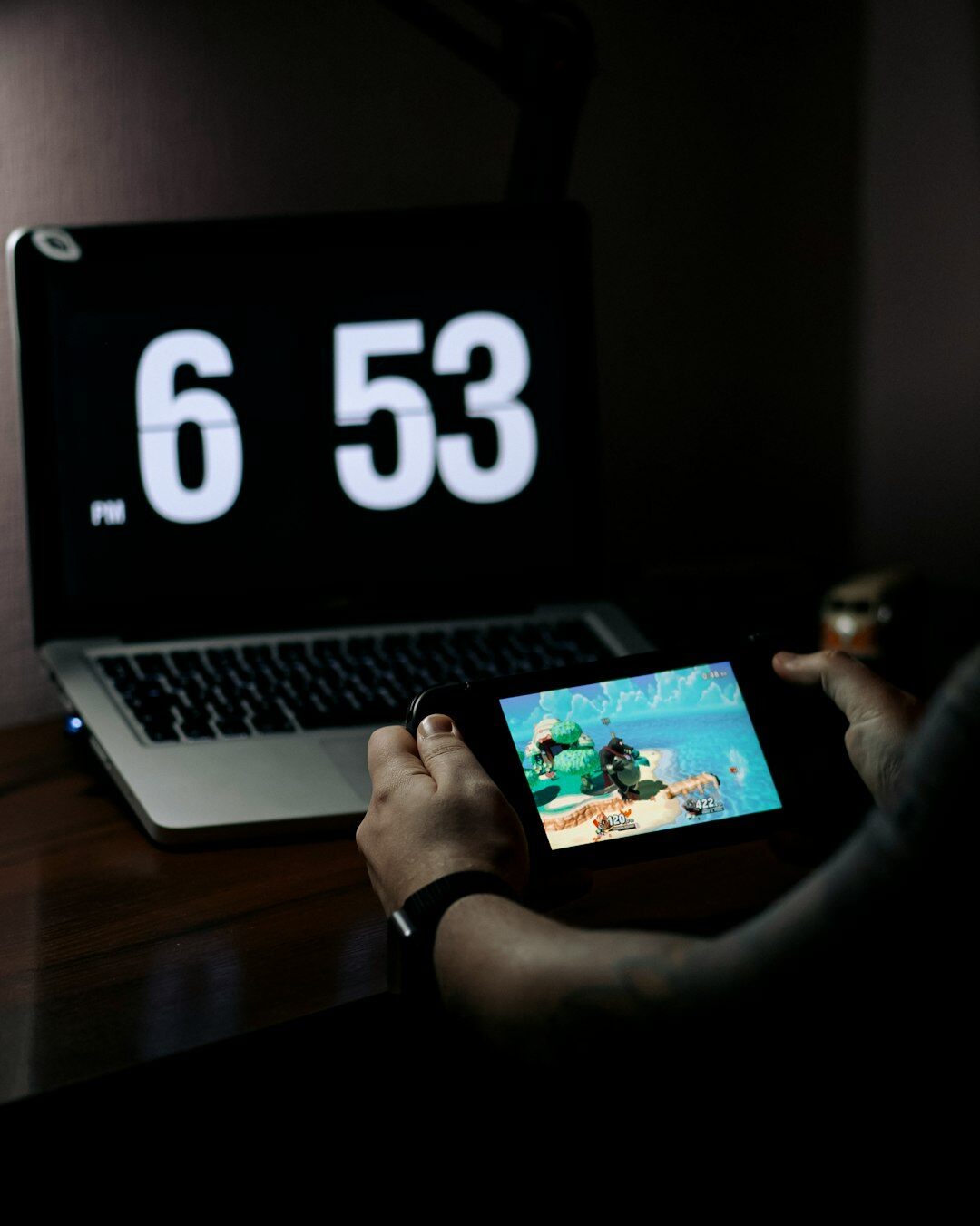 Hands typing on laptop with broadcast schedule on screen